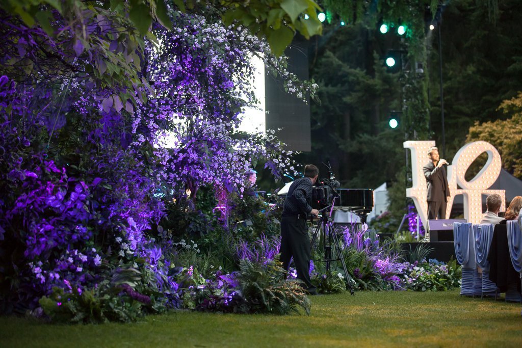 A stunning cherry blossom tree enhances an outdoor wedding setup at VanDusen, creating a romantic floral backdrop.