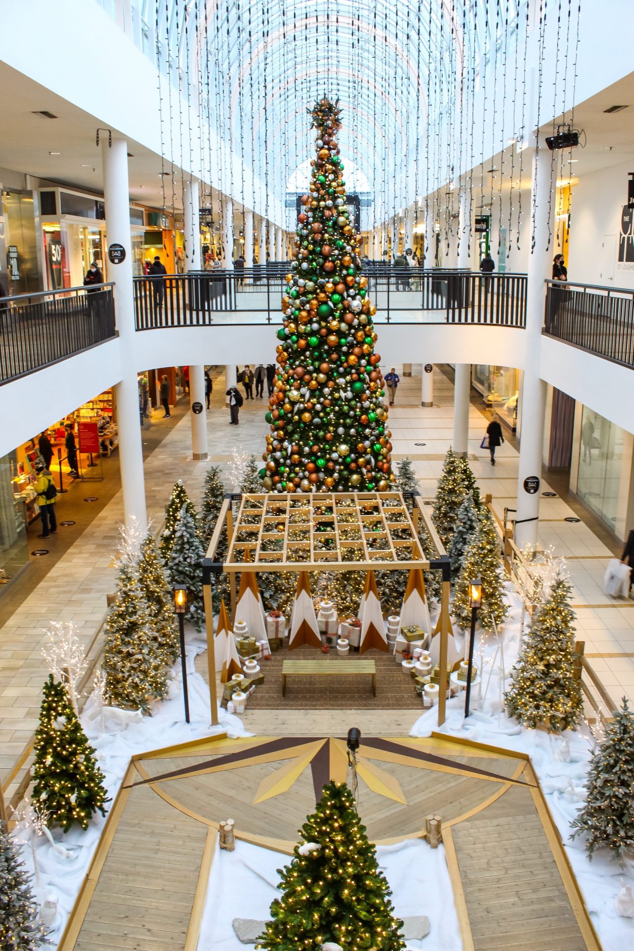 wide shot of gold and white holiday santa set turned into distanced walk through experience