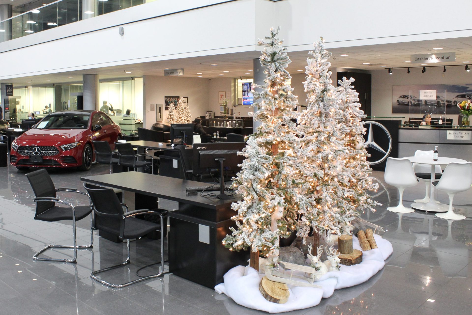 wintery flocked alpine tree vignettes with snow blanket base in car dealership