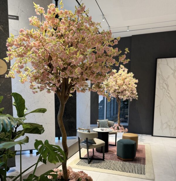 8' artificial cherry blossom tree, featuring delicate pink blossoms in a white interlocking planter.