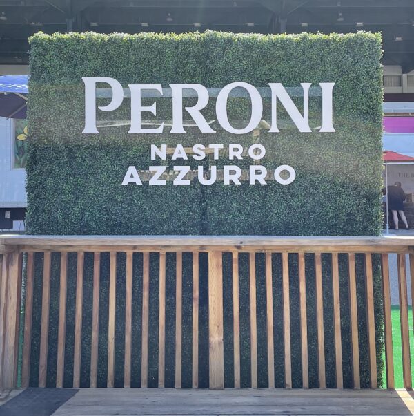 Artificial boxwood hedges with custom event branding, perfect for outdoor Vancouver patio photo ops.