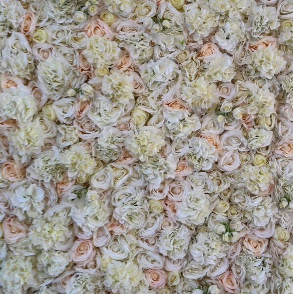 Faux floral wall featuring white, blush, and cream roses and hydrangeas in a romantic design.