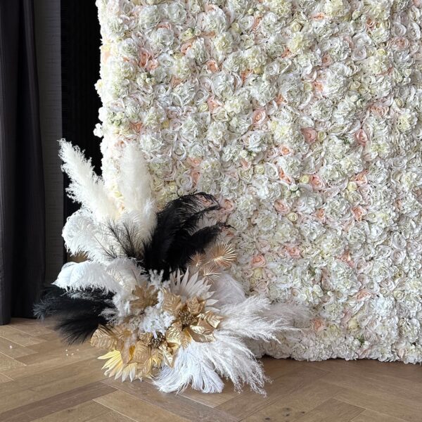 Elegant white floral backdrop with feathers and gold accents, perfect for weddings or upscale events in Vancouver.