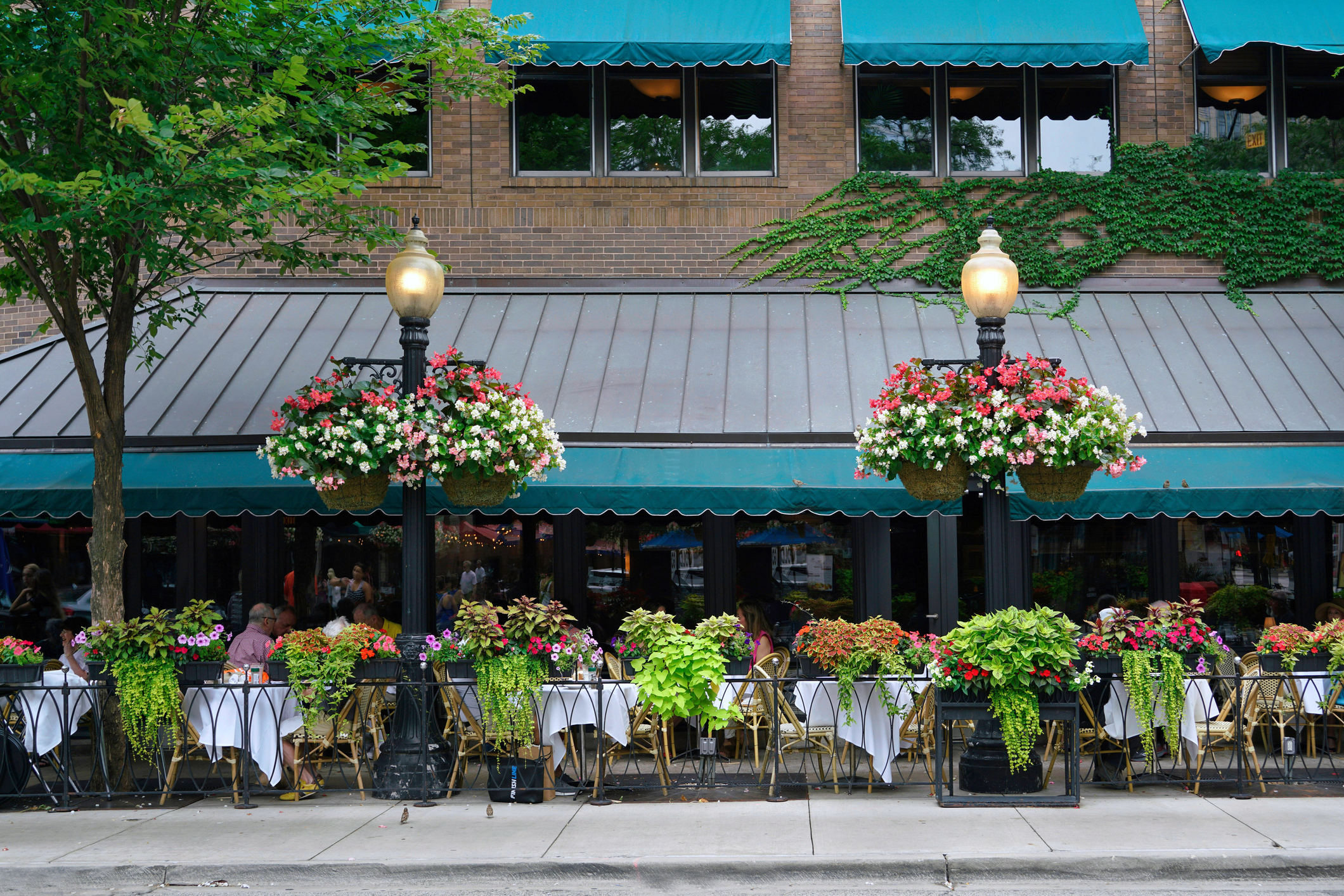 restaurant outdoor dining tables decorated with flowers