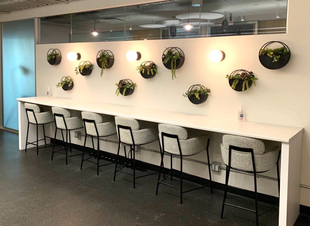 artificial plants arranged over a workspace desk