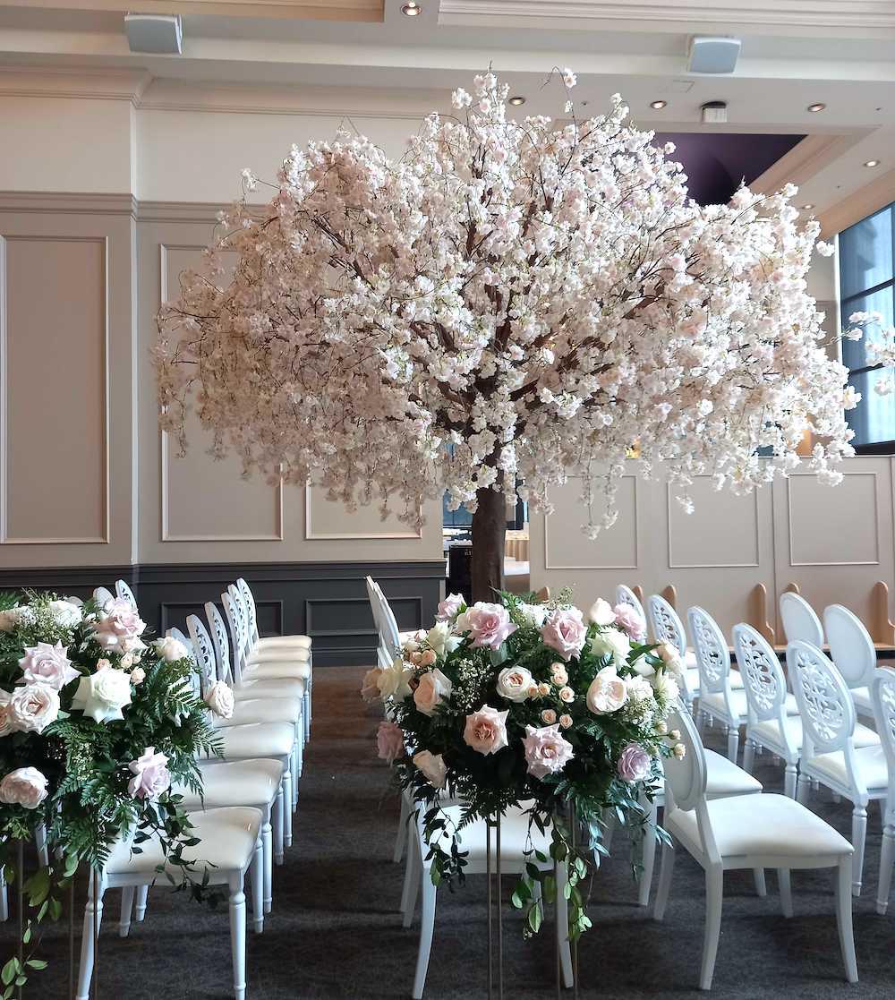 Cherry tree situated between chairs at a wedding venue