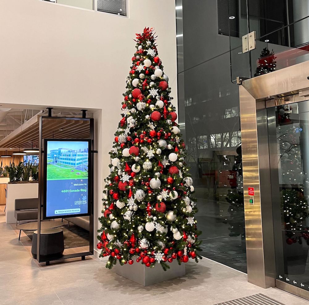 12-foot tall commercial Christmas tree in red, white, and silver by Greenscape Design, available for hassle-free rentals in Vancouver.