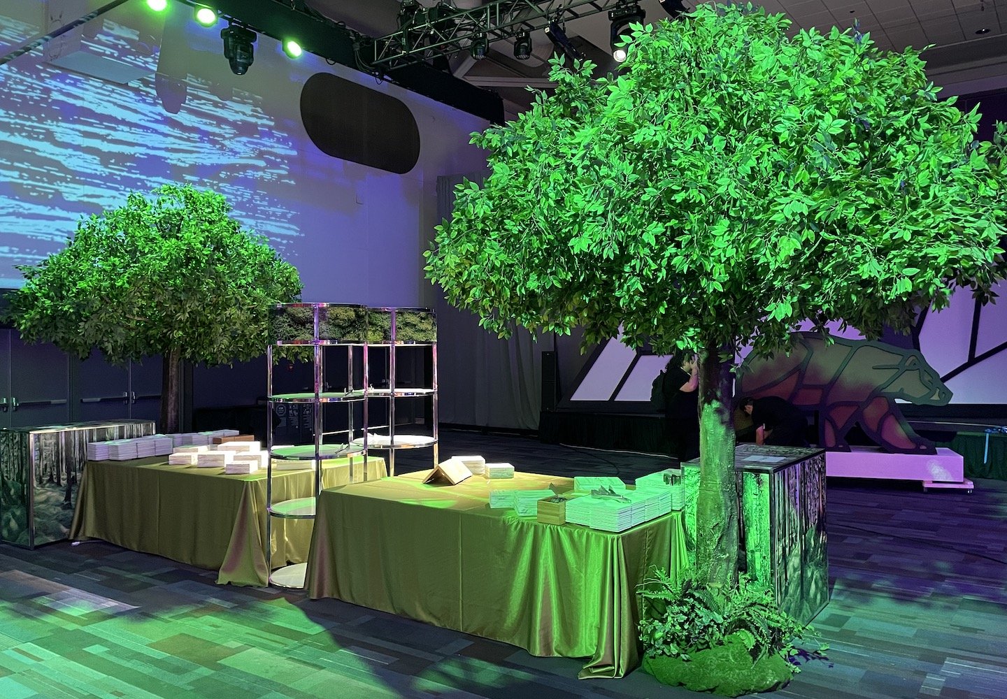 Artificial canopy trees by Greenscape Design at a corporate event, placed next to buffet tables.