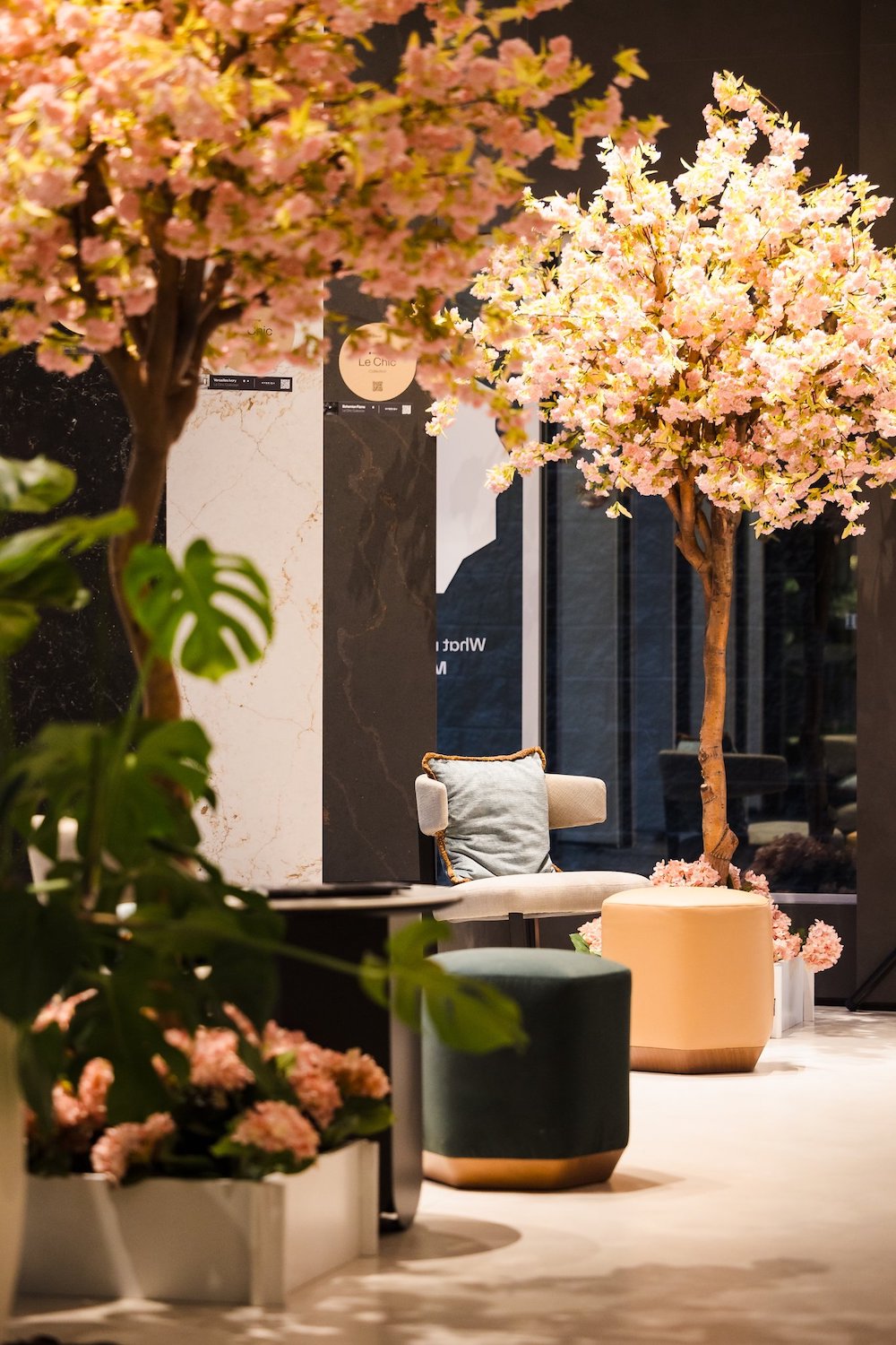 Replica cherry trees lining a window of a commercial office, part of Greenscape Design's artificial cherry tree rentals.