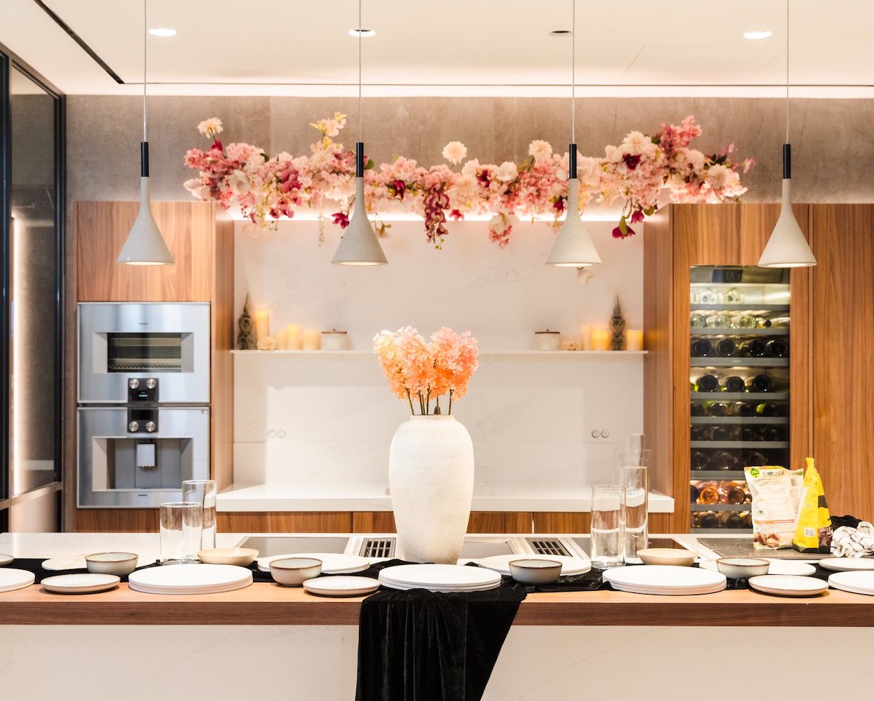 Pastel pinks and red florals suspended over a kitchen island.