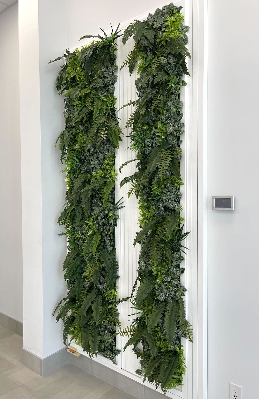 Custom artificial green wall by Greenscape Design, enhancing commercial interior design in Vancouver.