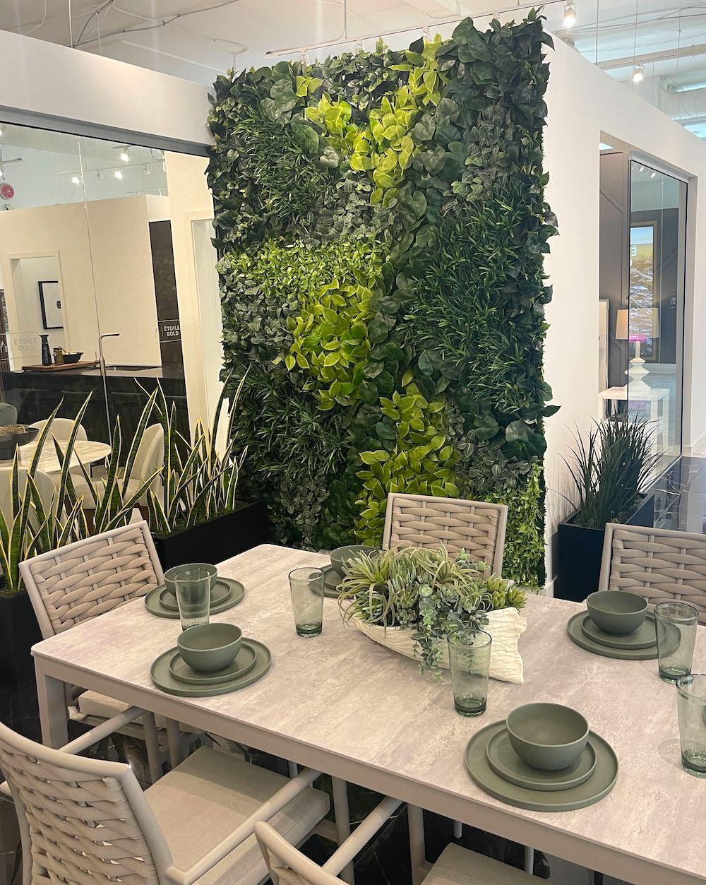 Fire retardant artificial greenery on an office wall with sansevieria plants in modern planters.