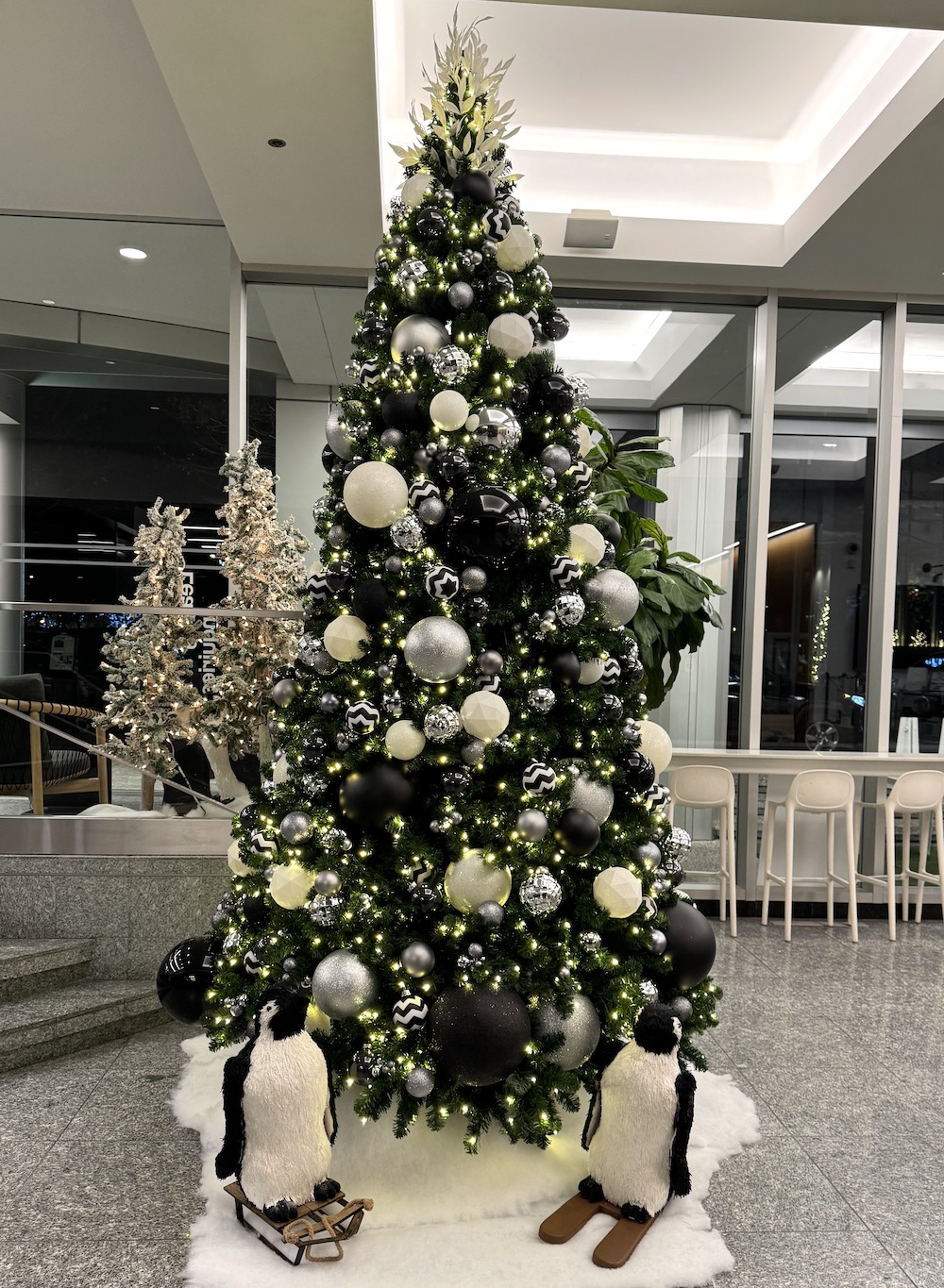 Holiday decor featuring black, white, and silver elements with penguin-themed accents by Greenscape Design in Vancouver.