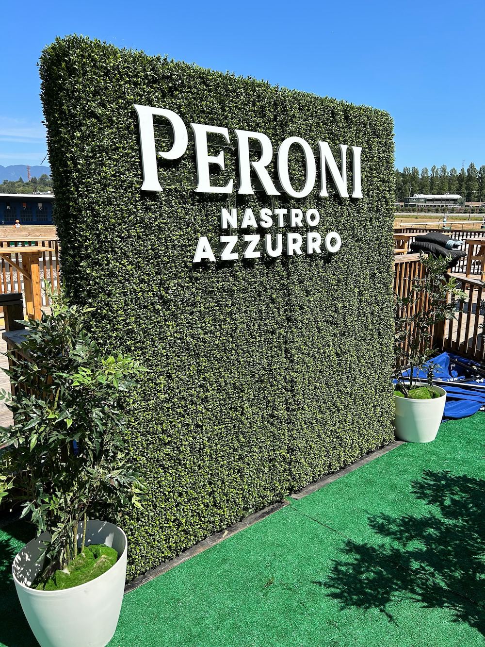 Boxwood hedge adorned with CNC custom lettering by Greenscape Design for event decor rental in Vancouver, partnering with Peroni.