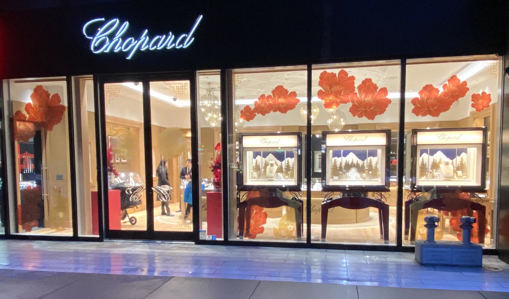 Greenscape Design's Lunar New Year window display on Alberni Street showcasing red vinyl decals and colorful floral arrangements.