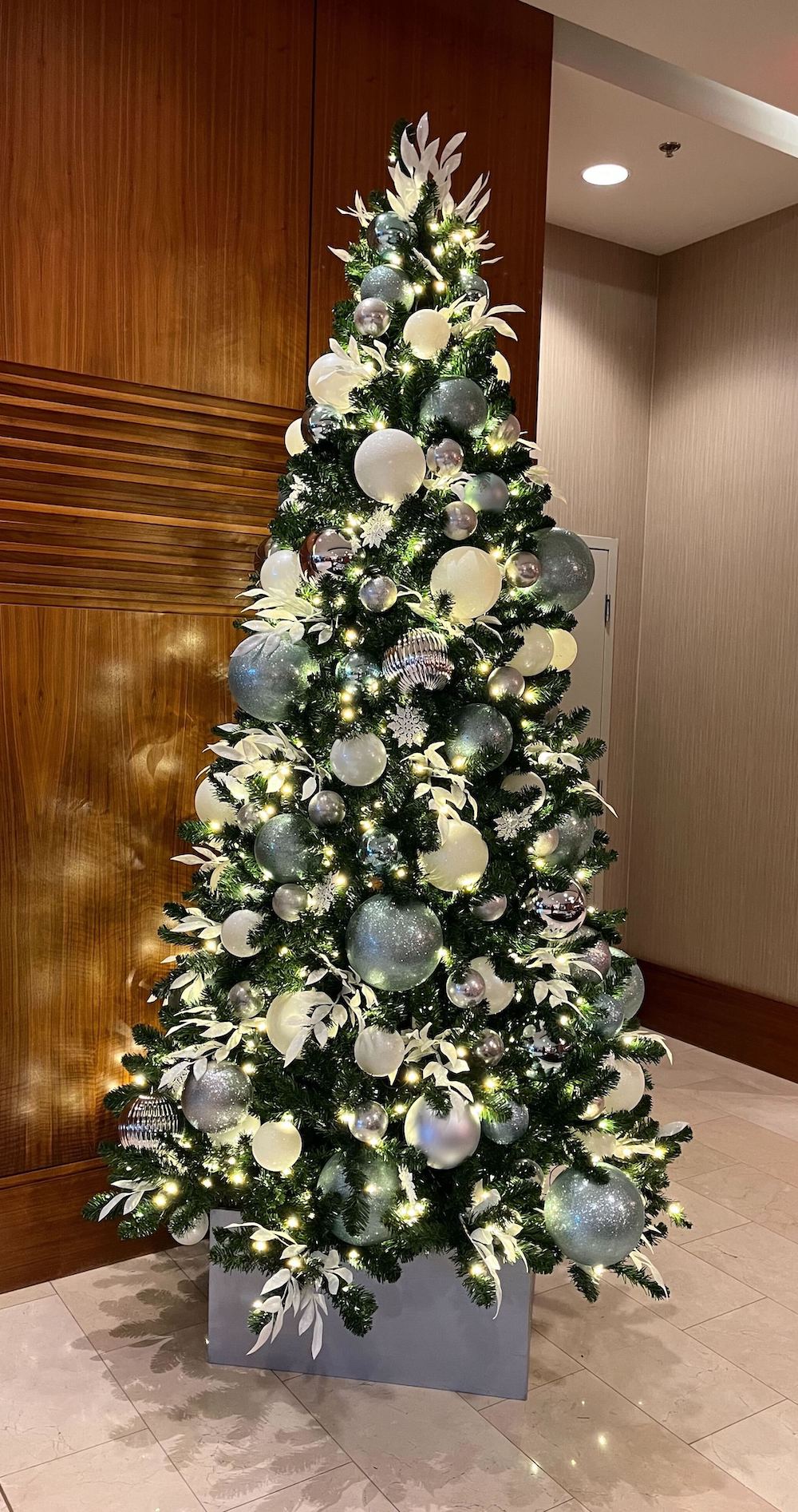 Greenscape Design brings the magic of a frozen wonderland to Coast Coal Harbour with blue, white, and silver holiday decor.