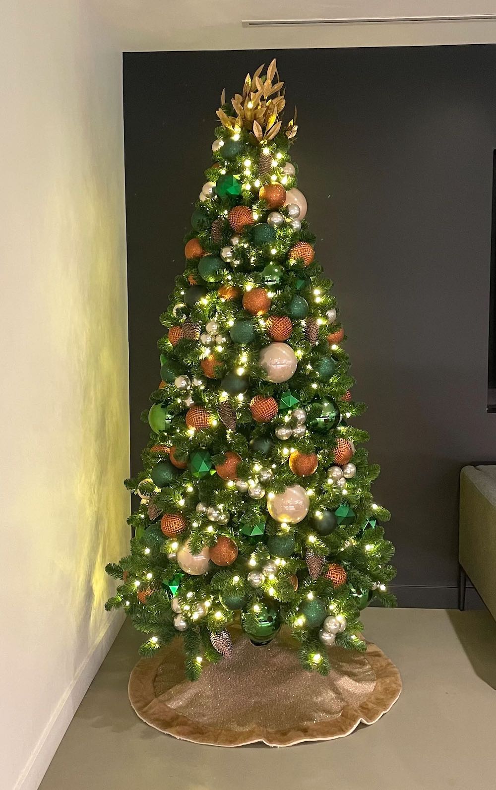 Christmas tree adorned in copper, emerald green, and oat hues by Greenscape Design in Vancouver.
