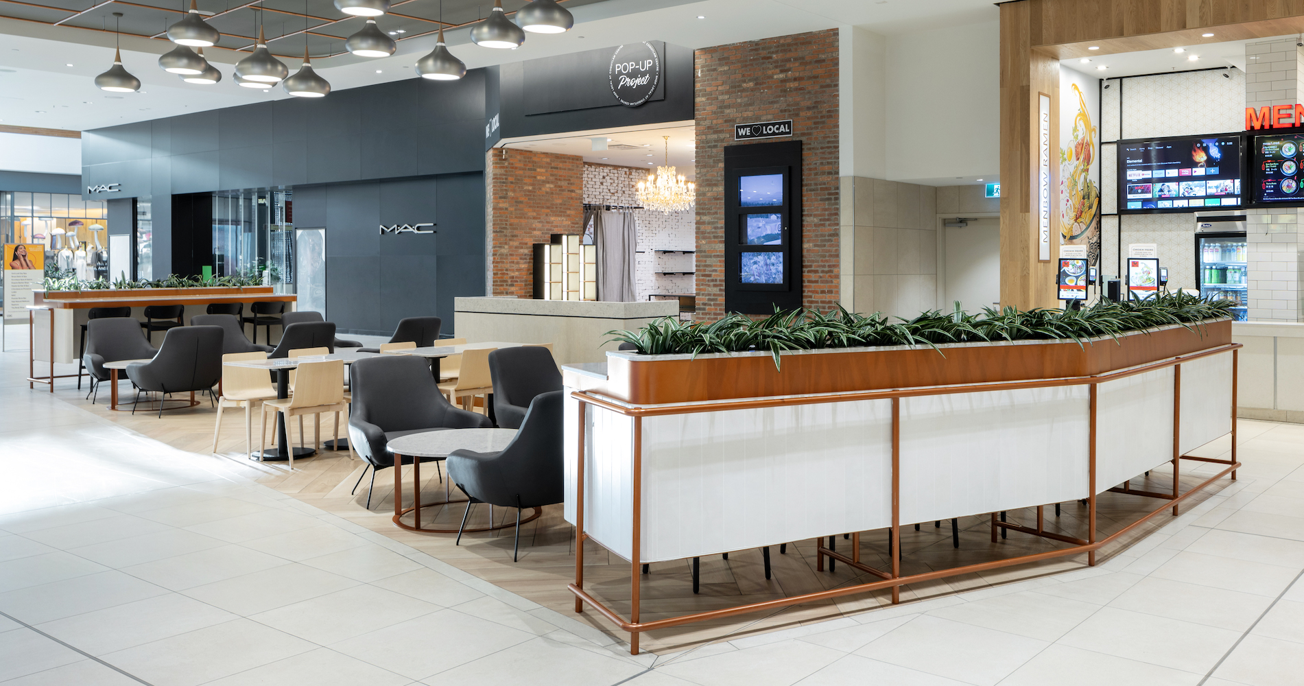 Artificial greenery planters by Greenscape Design framing guest seating areas at Coquitlam Centre eateries.