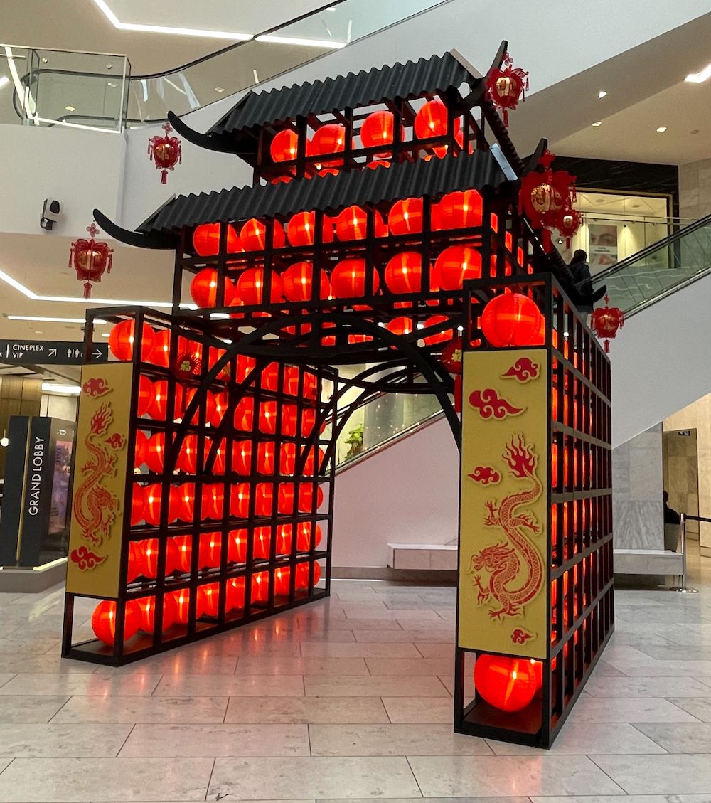 Vibrant Lunar New Year pagoda display by Greenscape Design at Brentwood. Engage with interactive lantern an dragon elements celebrating Chinese New Year traditions.
