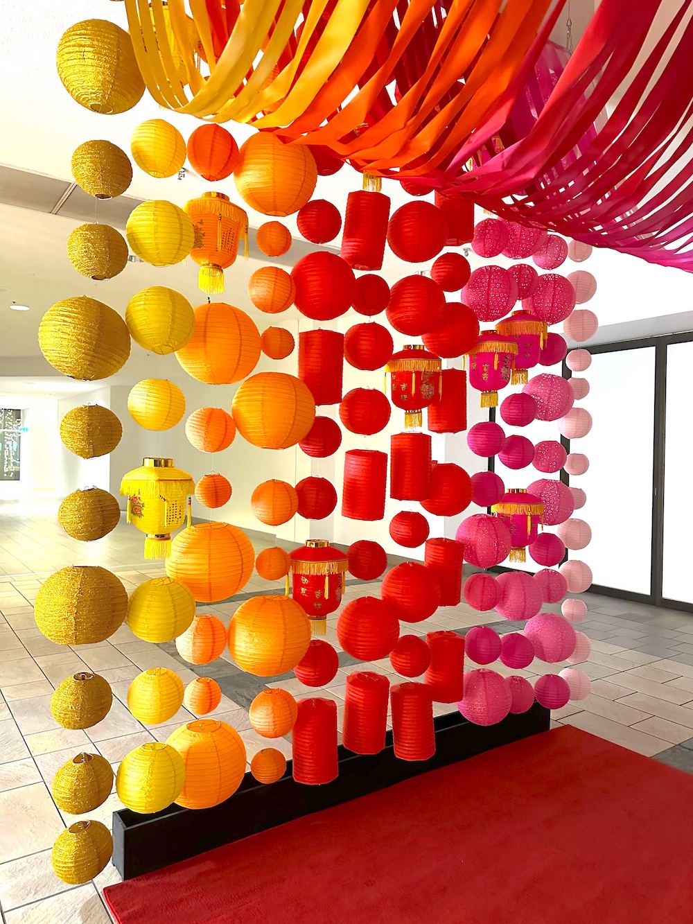Colorful lantern wall photo backdrop for Lunar New Year celebration by Greenscape Design at The City of Lougheed.