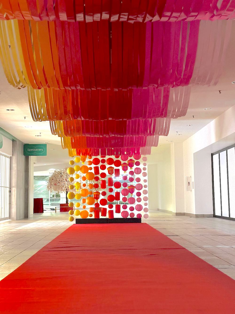 Festive Lunar New Year ribbon tunnel display at Lougheed Town Centre, created by Greenscape Design