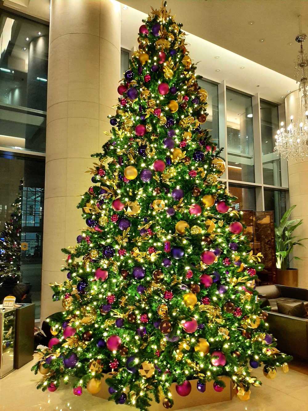 Modern jewel tone 16' foot tall tower Christmas tree at Shangri-La Hotel Vancouver lobby