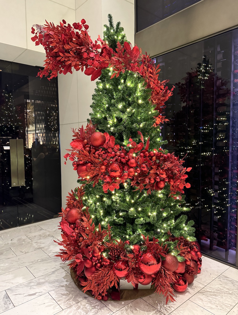 Festival of Trees Vancouver display, Modern red Christmas tree design by Greenscape Design, a custom holiday decor rental for hotels in Vancouver, adding a contemporary twist to traditional festivities.