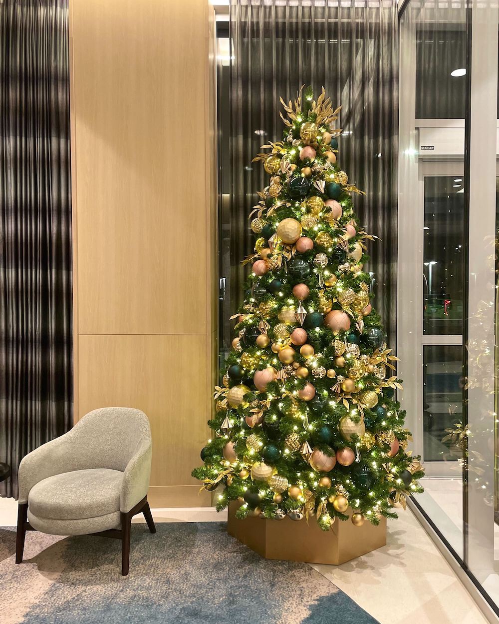 Modern teal and rose gold Christmas tree decor by Greenscape Design at Delta Hotel adds contemporary flair and festive charm to the holiday ambiance.