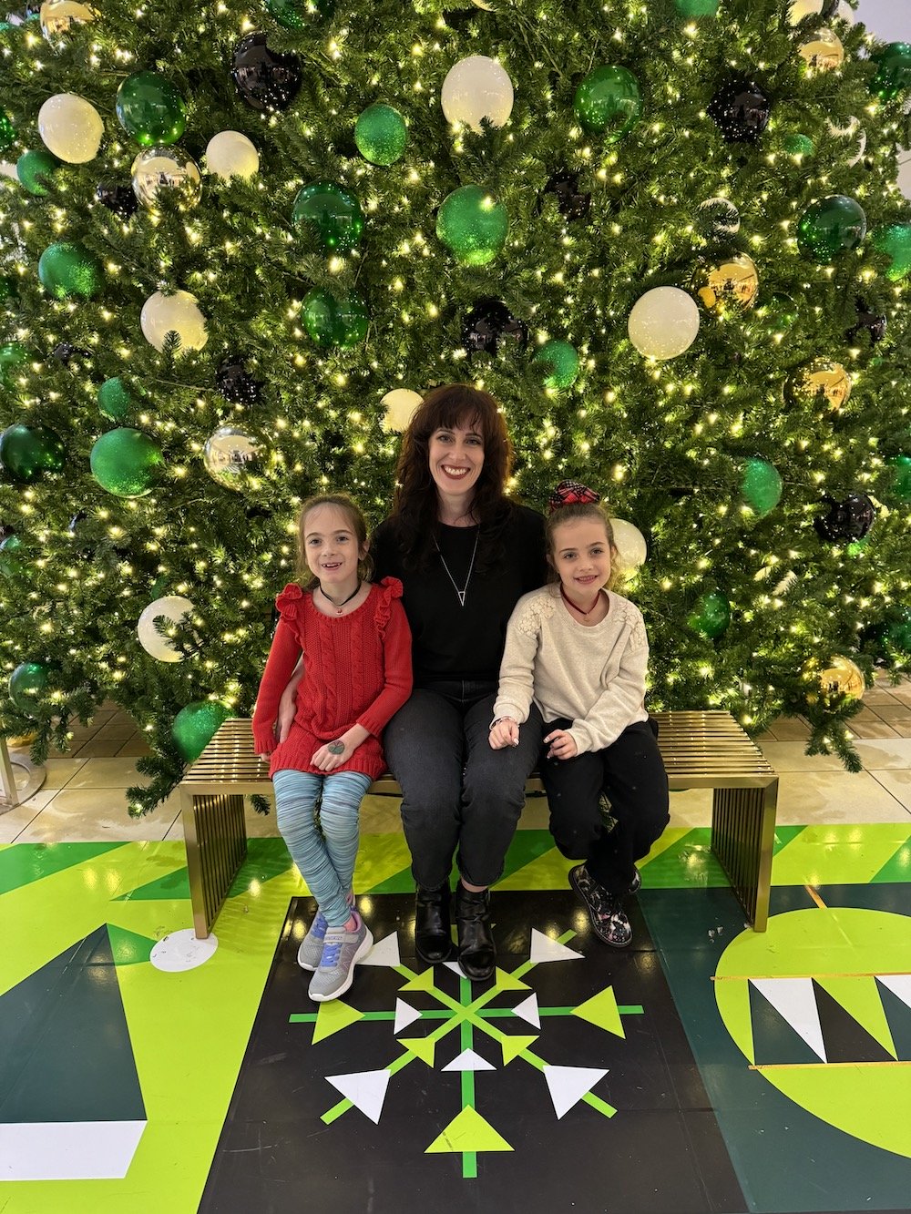 The City of Lougheed's 30ft Artificial Christmas Tree by Greenscape offers a grand backdrop for festive photos.