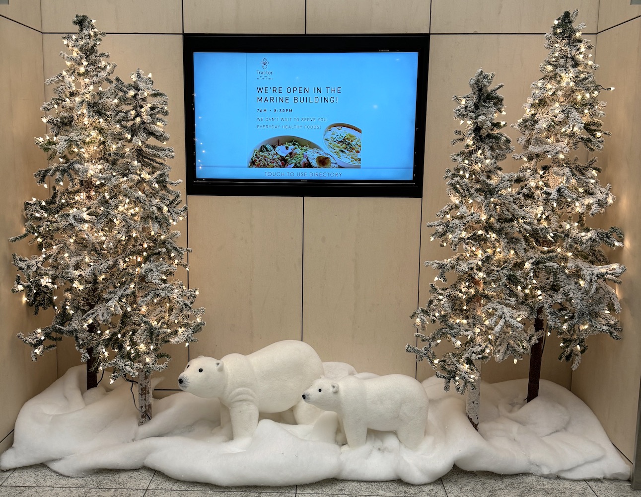 Flocked alpine trees and polar bear vignette create a winter wonderland by Greenscape Design in Vancouver.