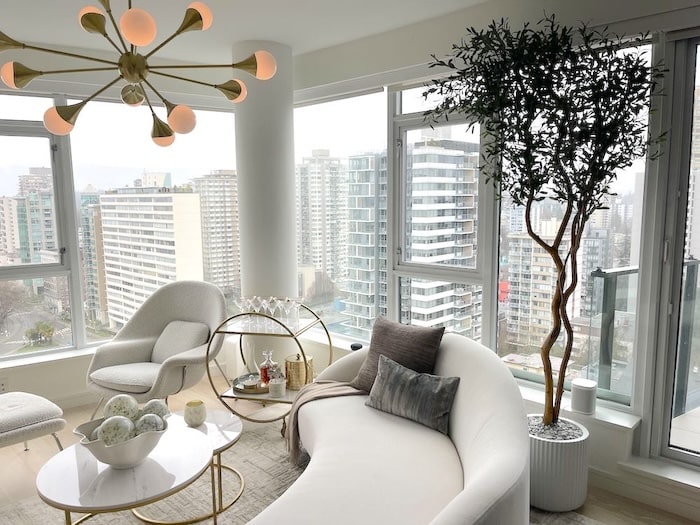 faux tree in the corner of a beautiful apartment living room