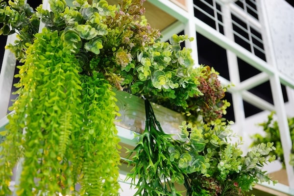 faux plants made from various artificial plant materials in a hanging potter