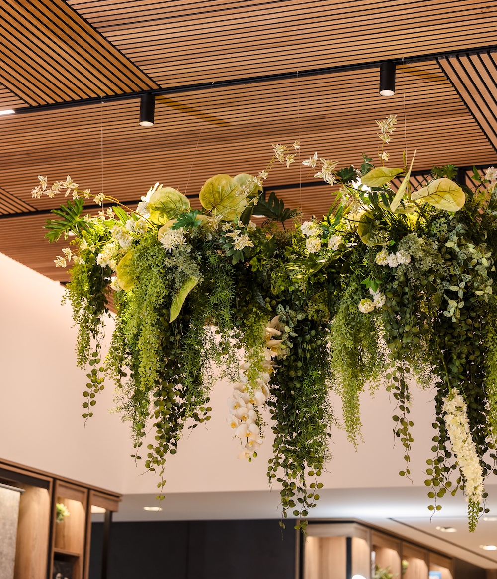 Artificial greenery chandelier hanging overhead for corporate event by Greenscape Design in Vancouver.