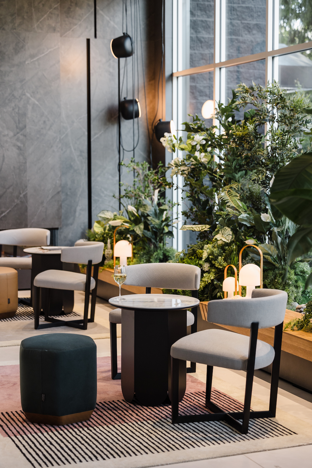 Artificial trees and greenery provide a natural backdrop for an event lounge by Greenscape Design in Vancouver.