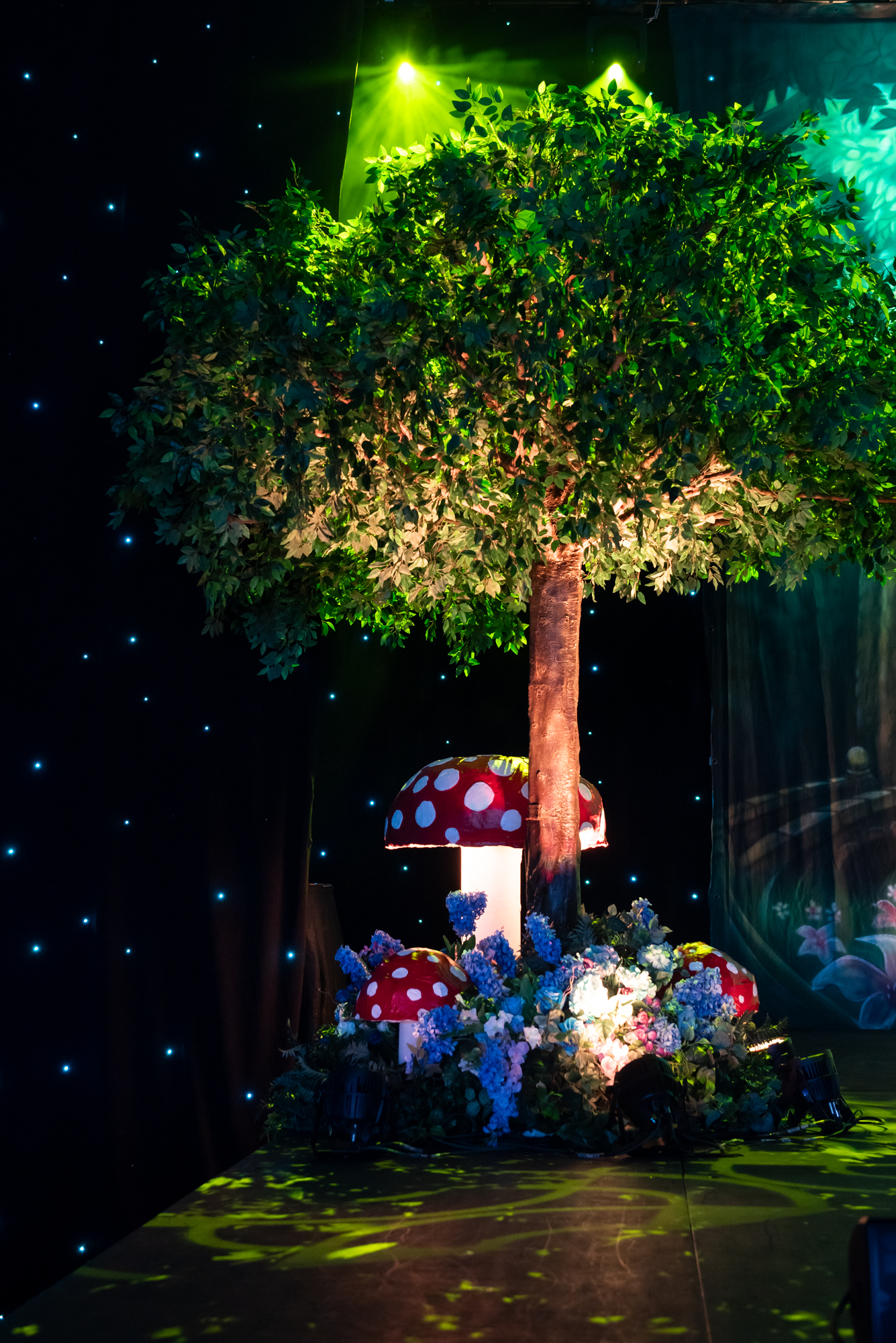 Custom canopy artificial apple tree with mushrooms and floral base by Greenscape Design in Vancouver.