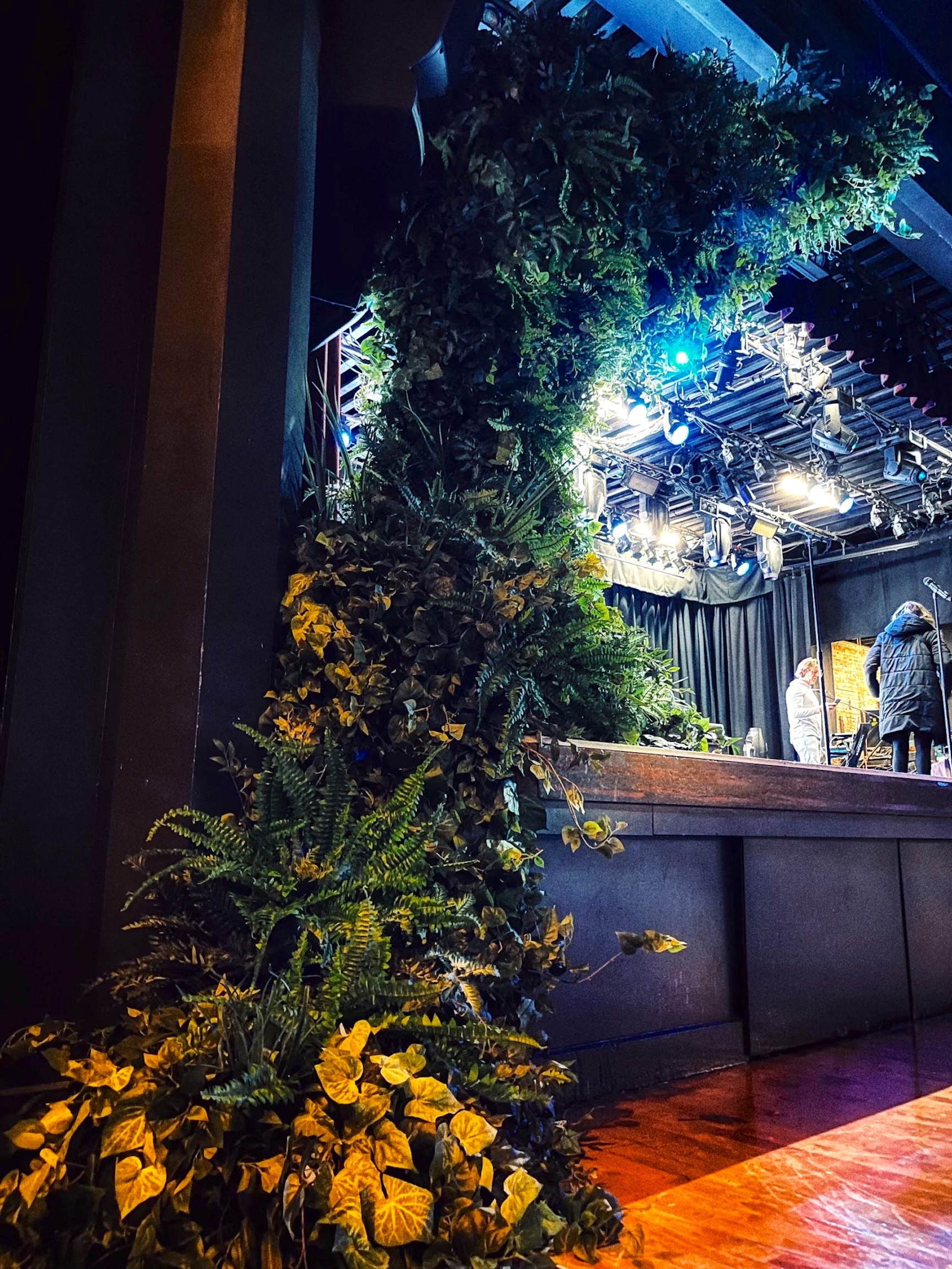 A dramatic greenery arch framing the stage at Commodore Ballroom, creating a lush and immersive event backdrop.