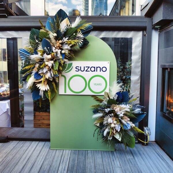 Custom wild sage green arched backdrop with dried and faux floral arrangements for custom event rentals.