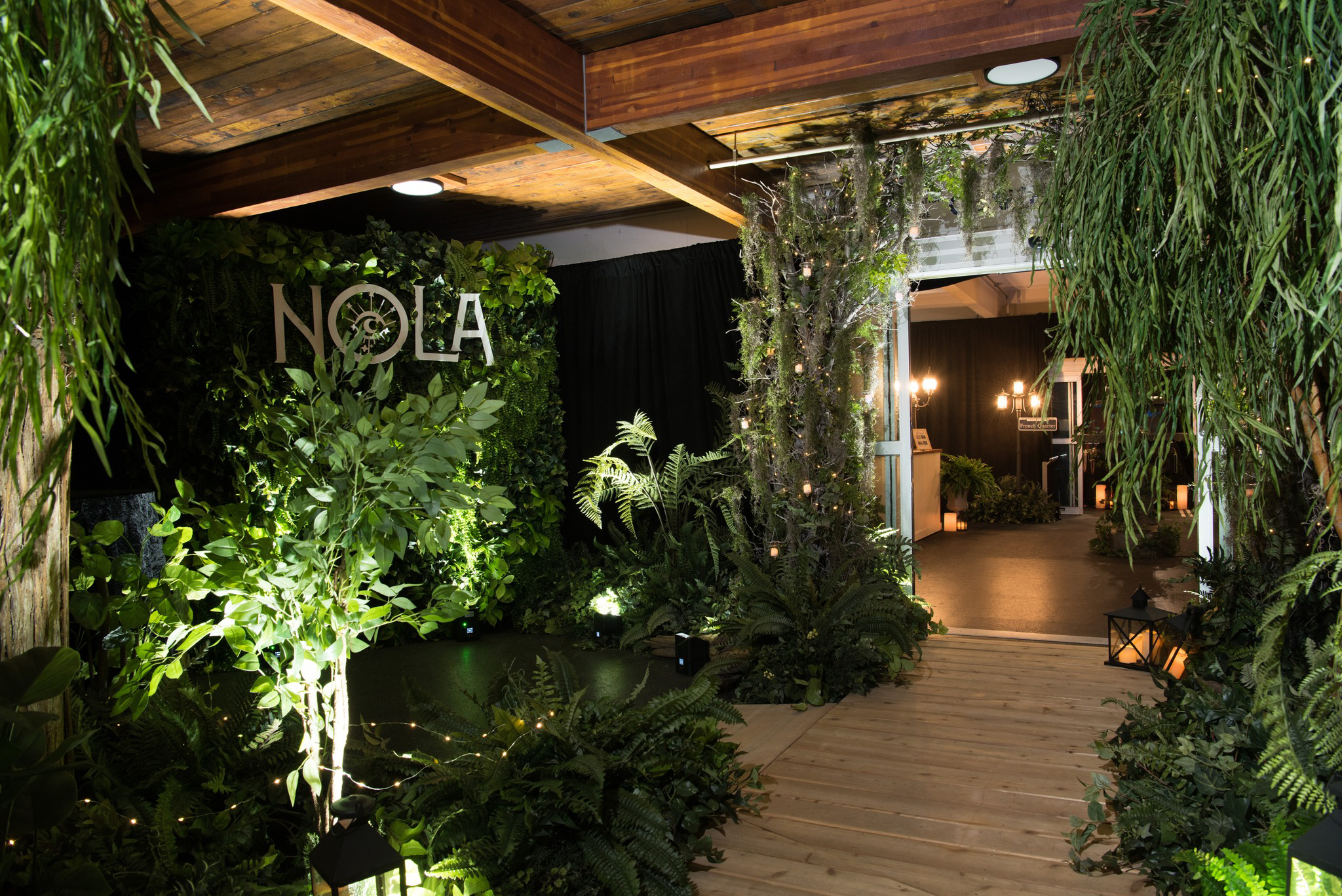 Entryway with artificial greenery trees for New Orleans themed event