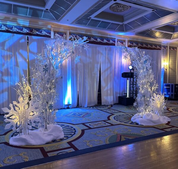 Winter Wonderland arch with snowflake details framing the entrance to a ballroom event.