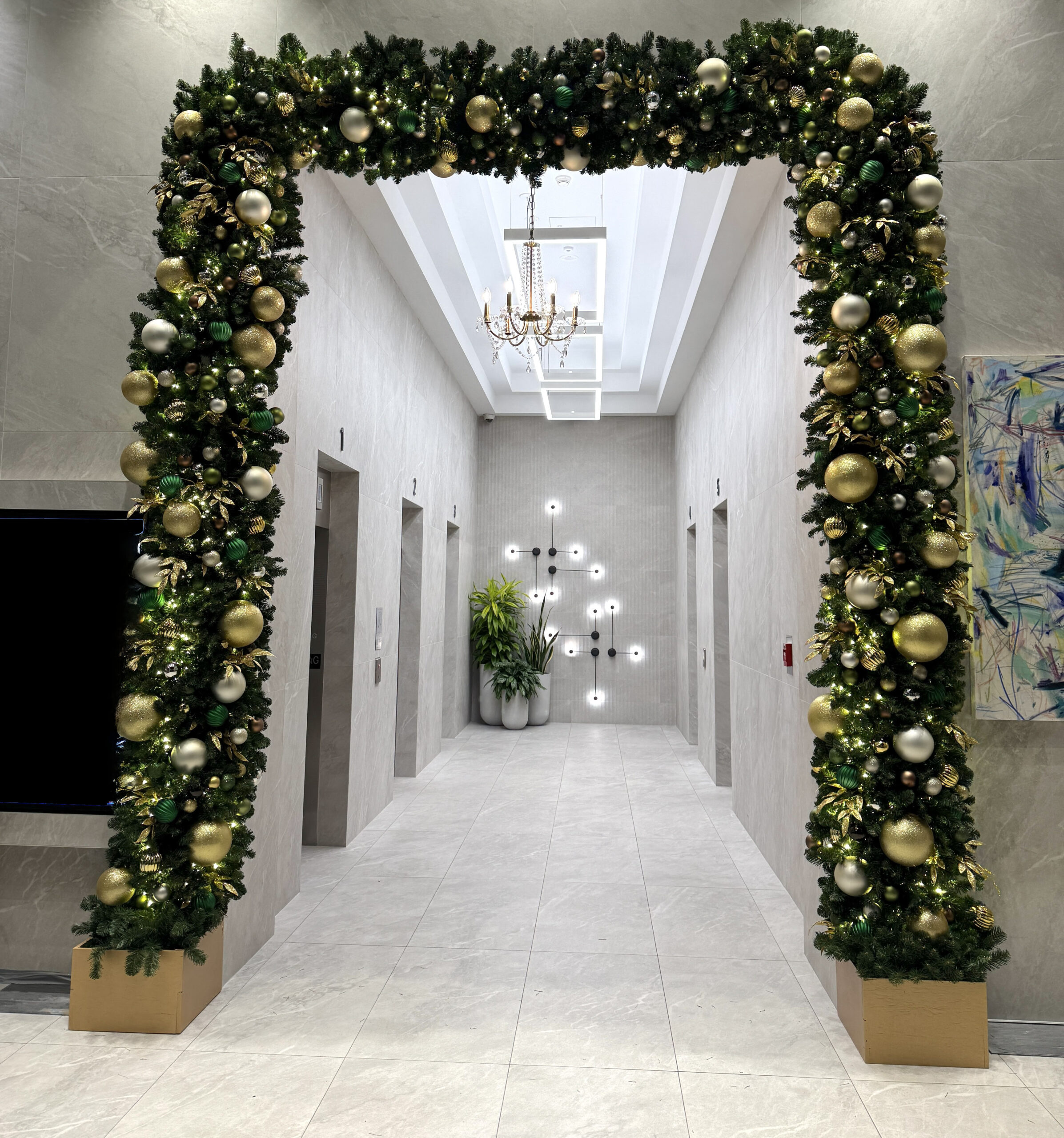 Christmas garland arch installed in commercial hallway entrance
