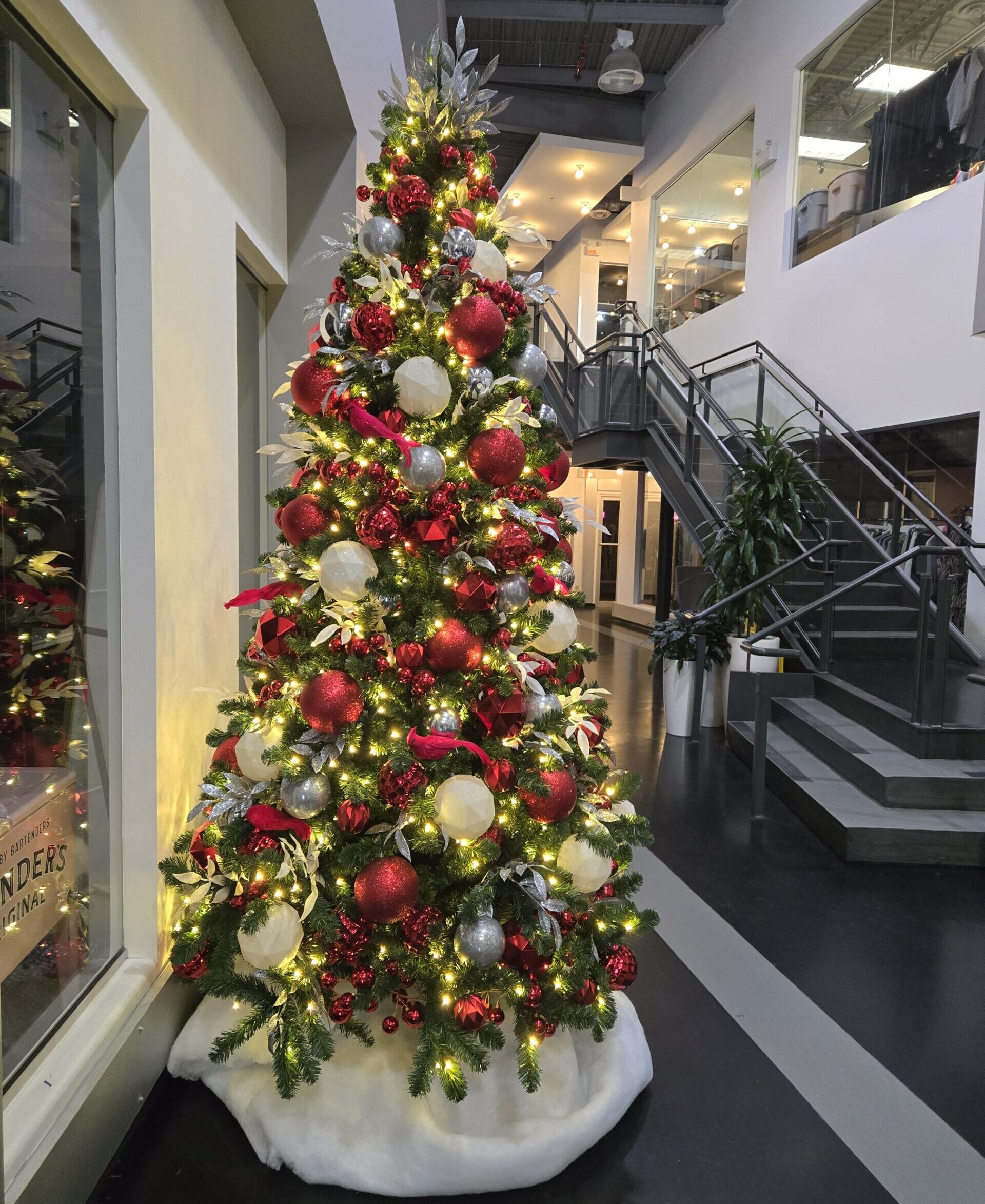Red and white themed Christmas tree in commercial lobby
