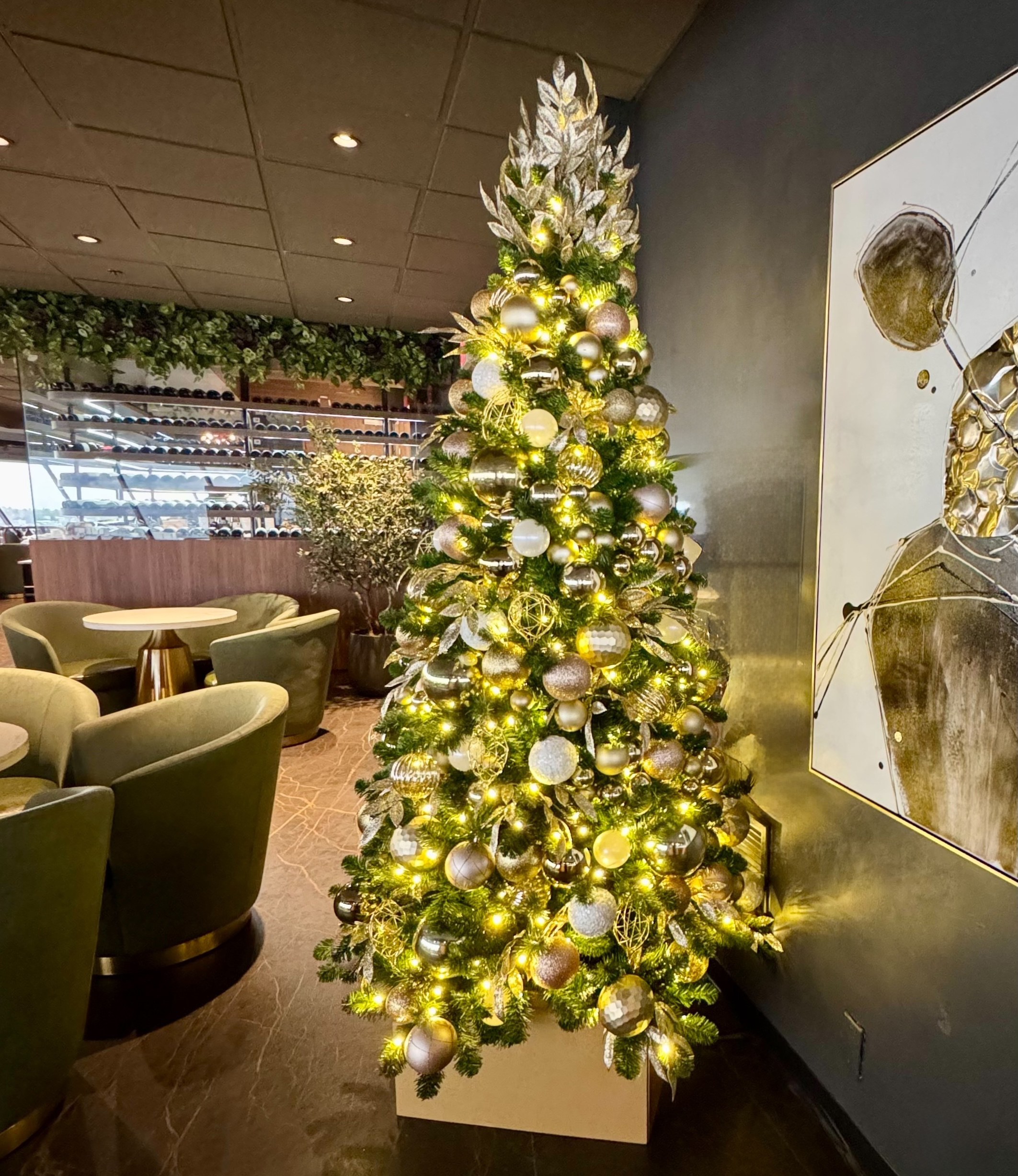 Christmas tree and décor arranged in commercial lounge seating area