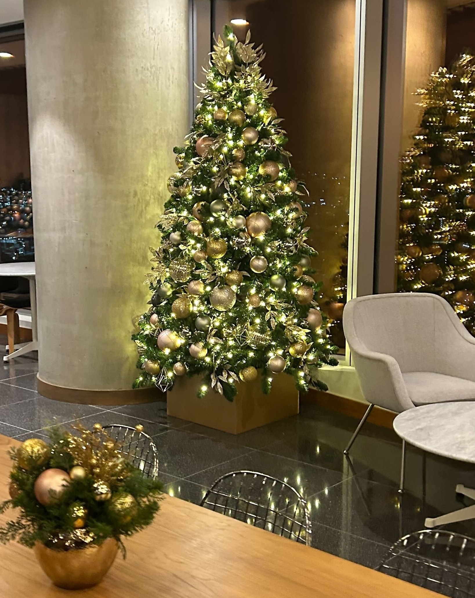 Gold themed Christmas tree in commercial lobby