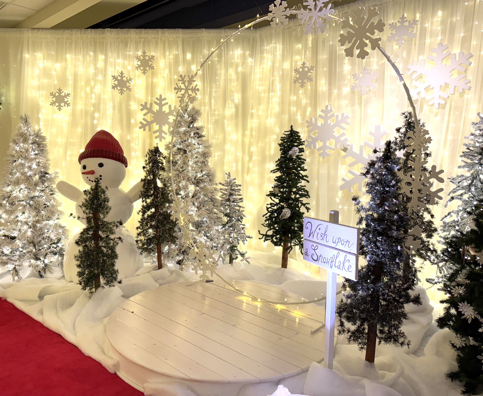 Walk-through snowglobe Christmas display with lit trees in shopping mall