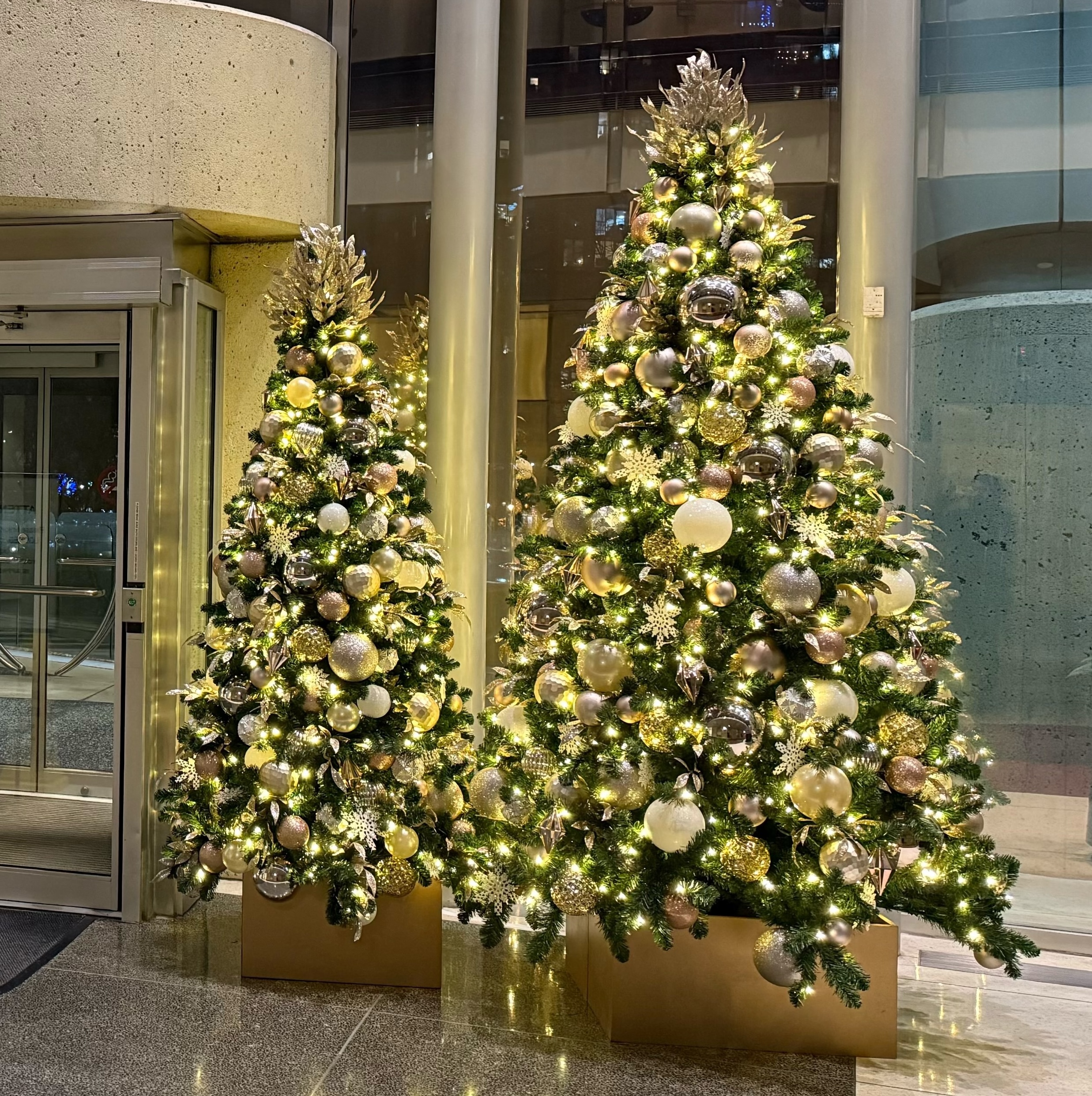 Two modern Christmas trees in office lobby