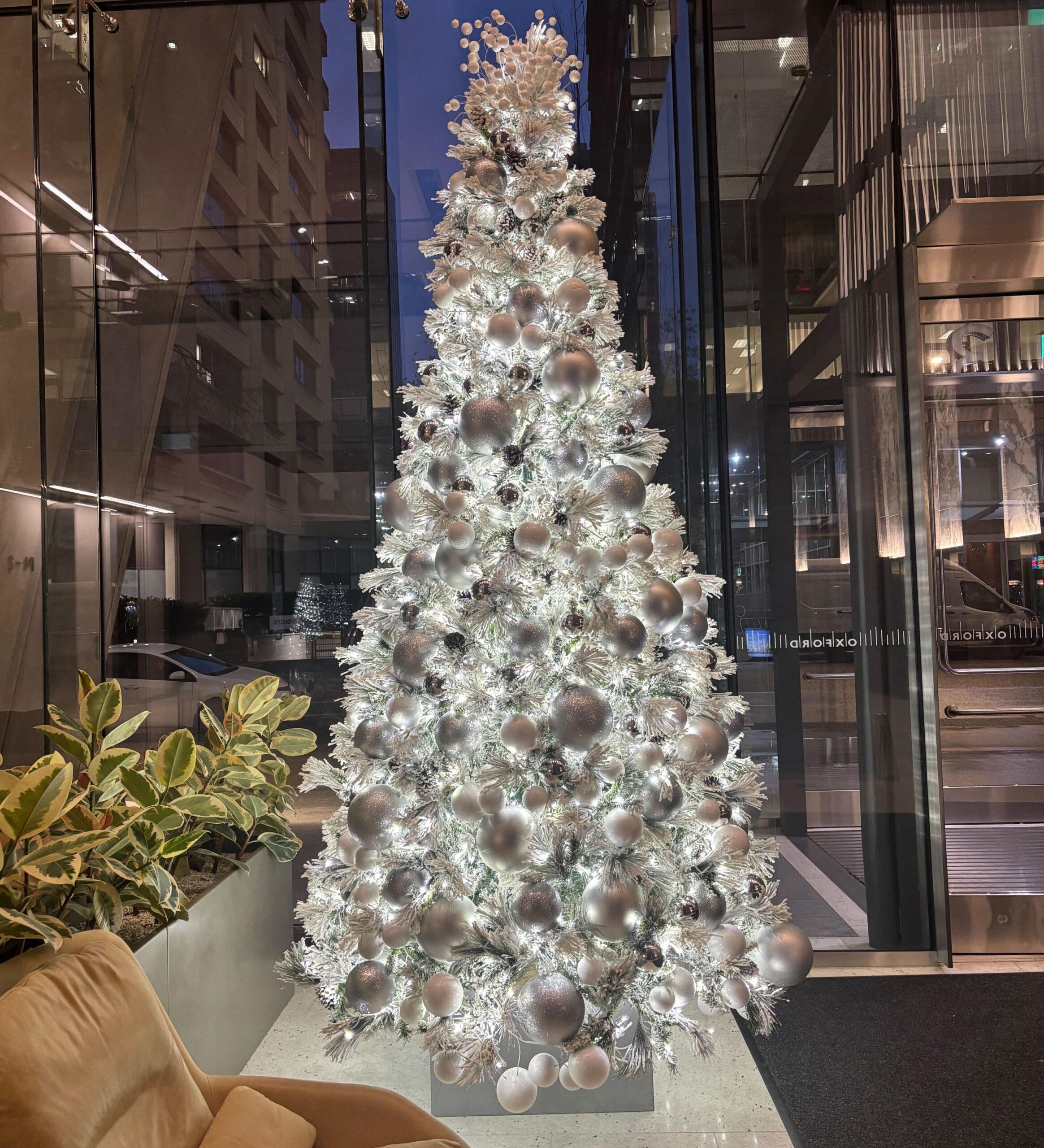 Artificial Snow covered Christmas tree in office lobby