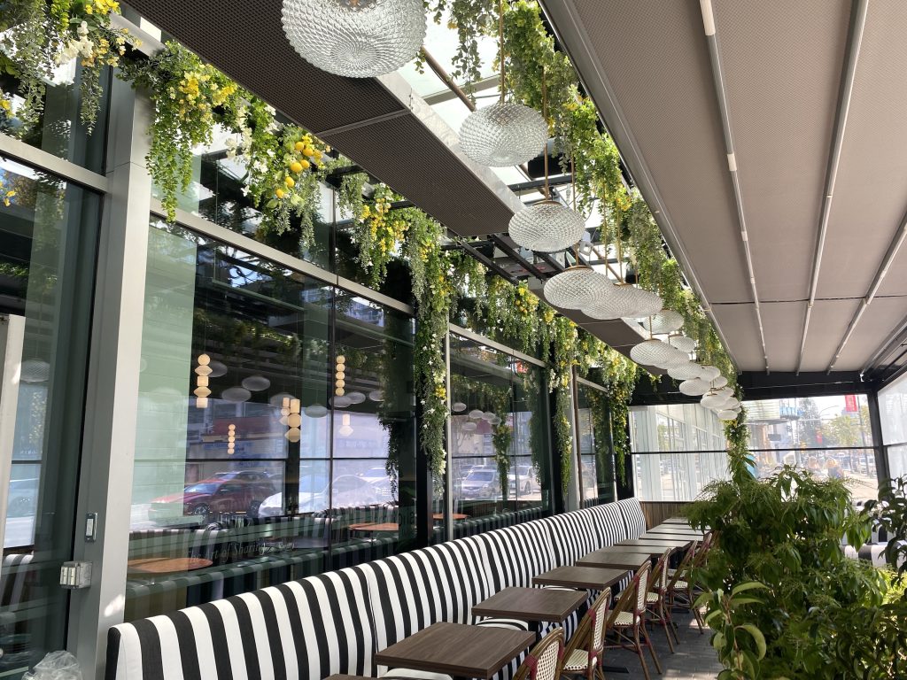 Restaurant patio with artificial exterior hanging greenery