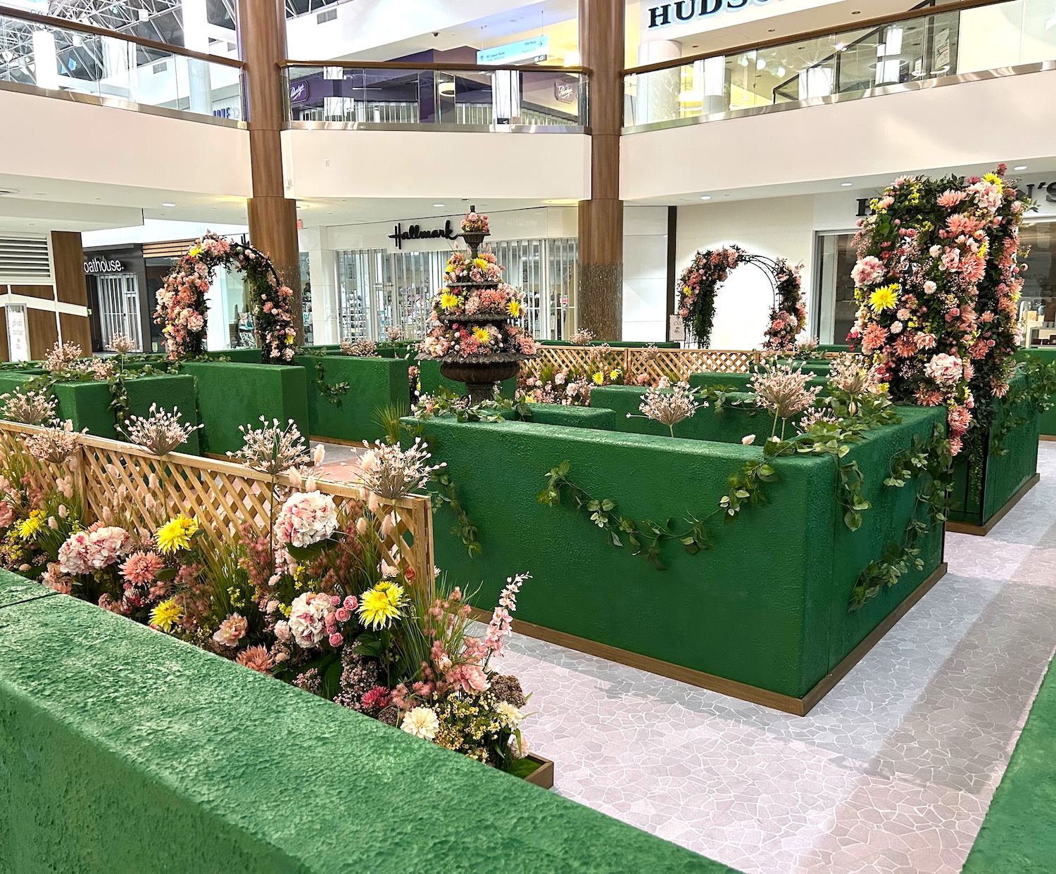 Spring flower hedge display with raised garden beds in shopping centre atrium