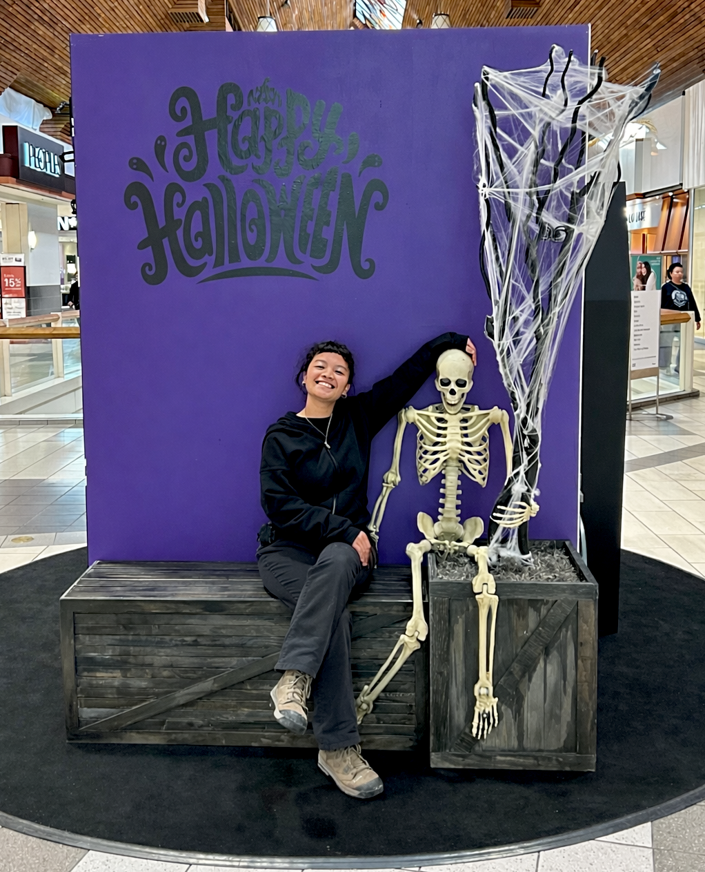 Halloween photo backdrop with skeleton and spider web decoration in shopping mall