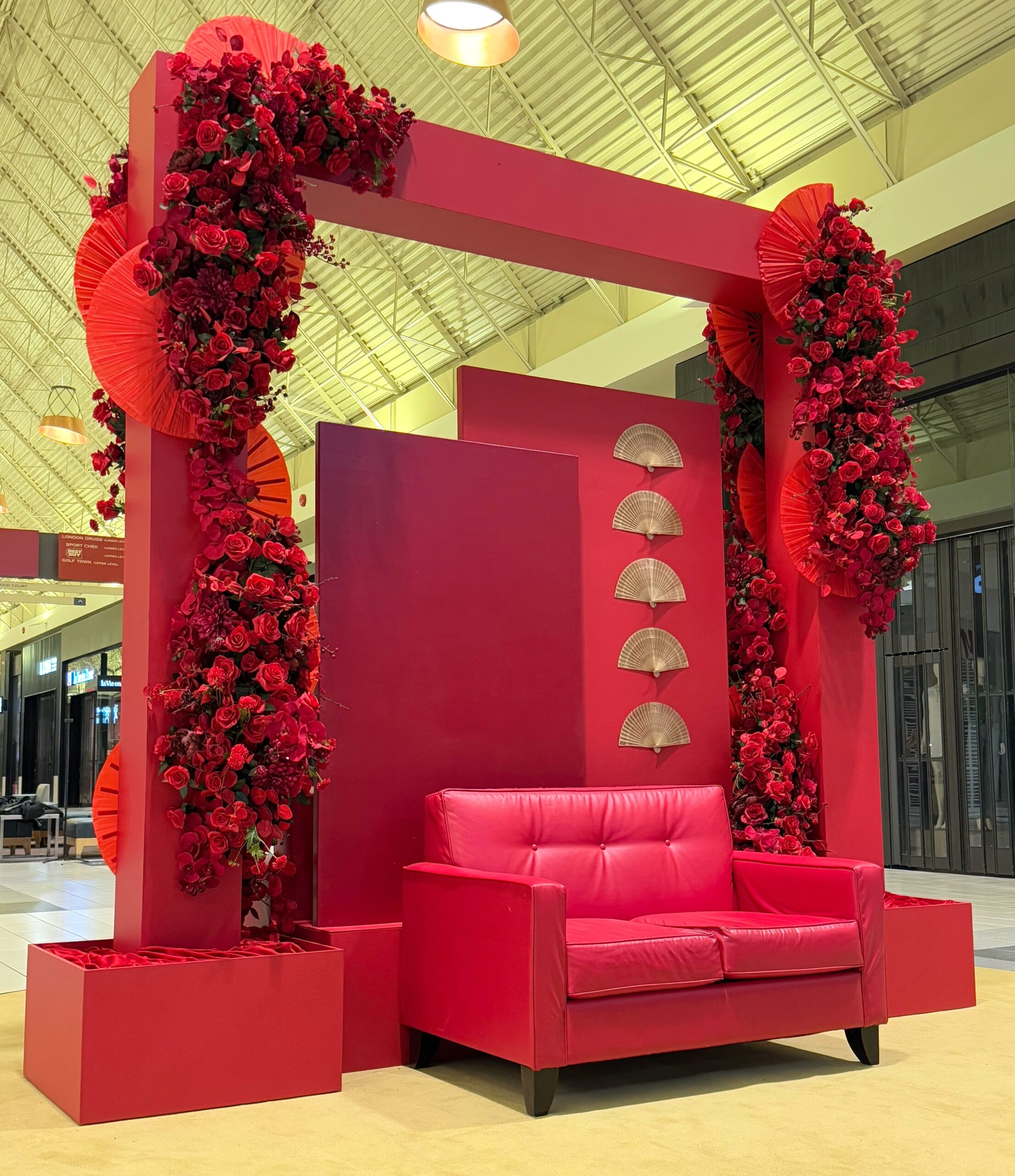 Red Lunar New Year display with decorative arch and festive floral arrangements